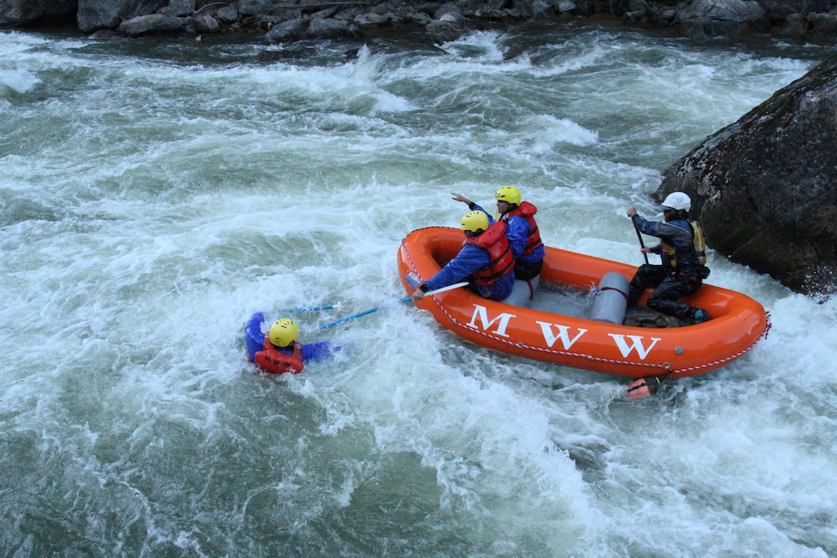 rafting getting rescued by rafters in a boat