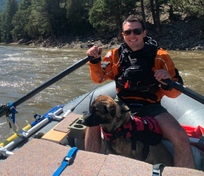 man rafting with his dog